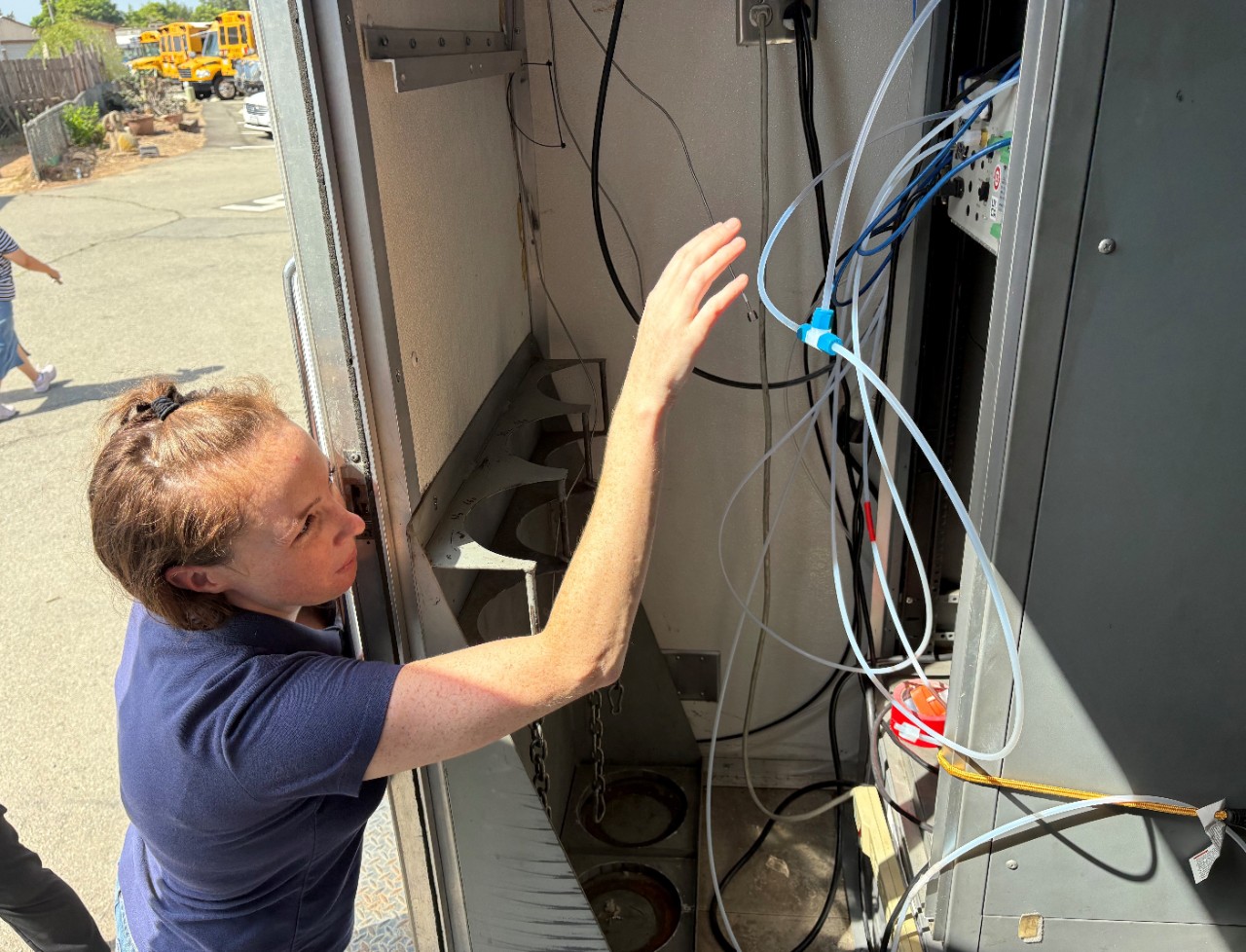 Picture of Community Monitoring staff taking air quality readings in the Tijuana River Valley.