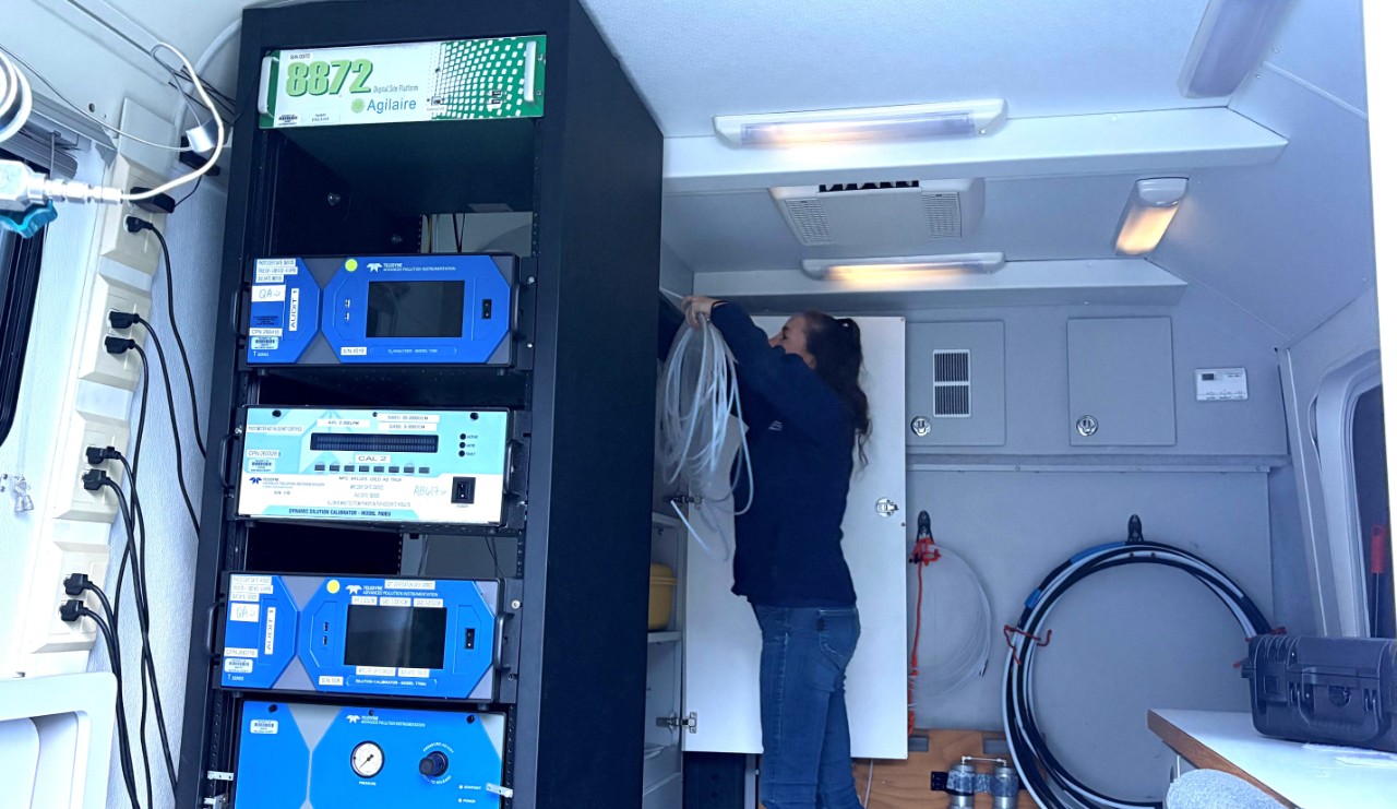 Woman behind air monitoring equipment