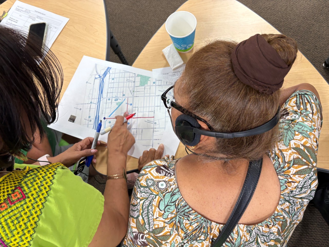 Portside Community Steering Committee member points at a map of their community.