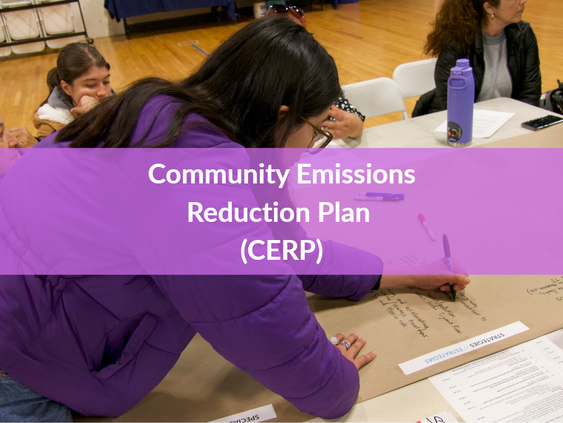 Community members write down emissions reduction strategy on paper