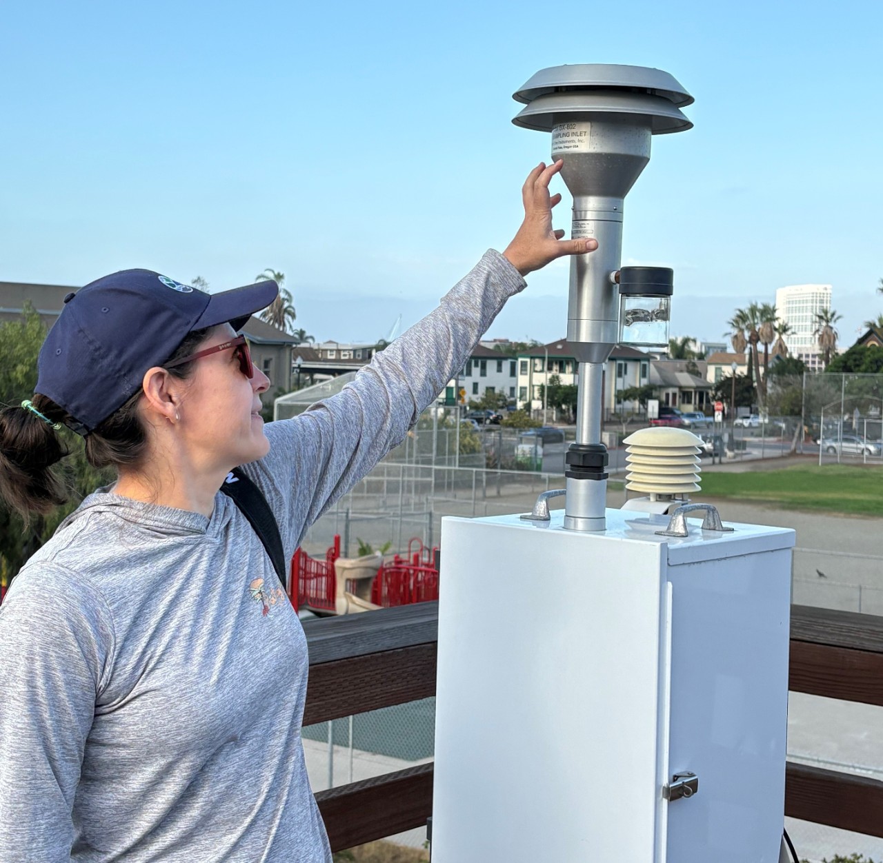 Chemist motions to air monitoring equipment.