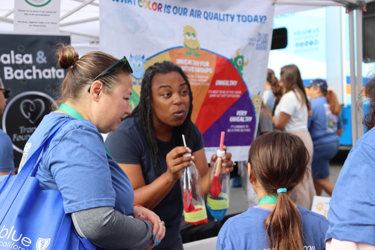 SDAPCD staff demonstrates a lung model for community members.